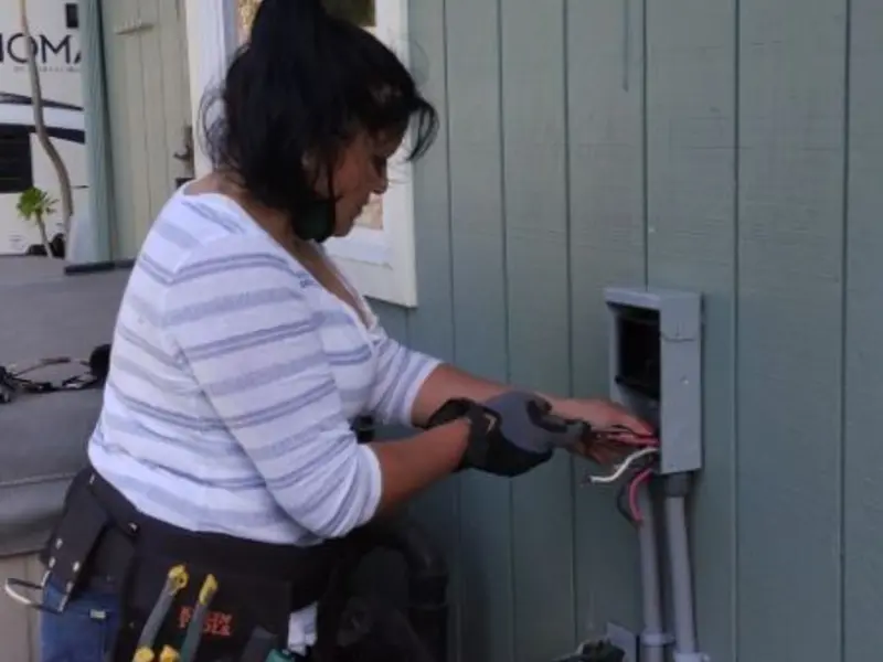 Licensed electrician wiring an exterior subpanel in Midfield