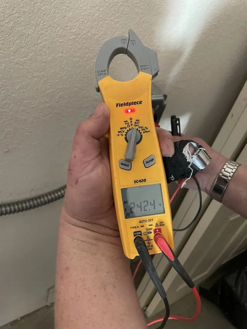 Voltage testing with clamp meter during Whole House Surge Protector in Midfield